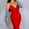A woman wearing a red dress and black and white checkered latex gloves.