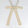 A beige ribbon tie set featuring a bow and two long strips, suitable for students.