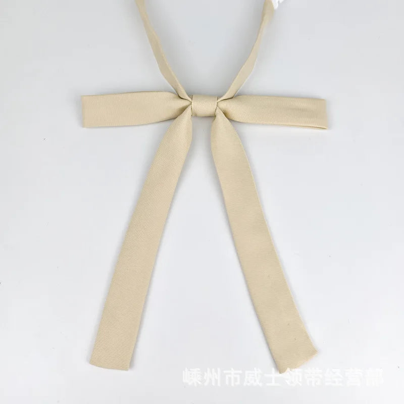 A beige ribbon tie set featuring a bow and two long strips, suitable for students.
