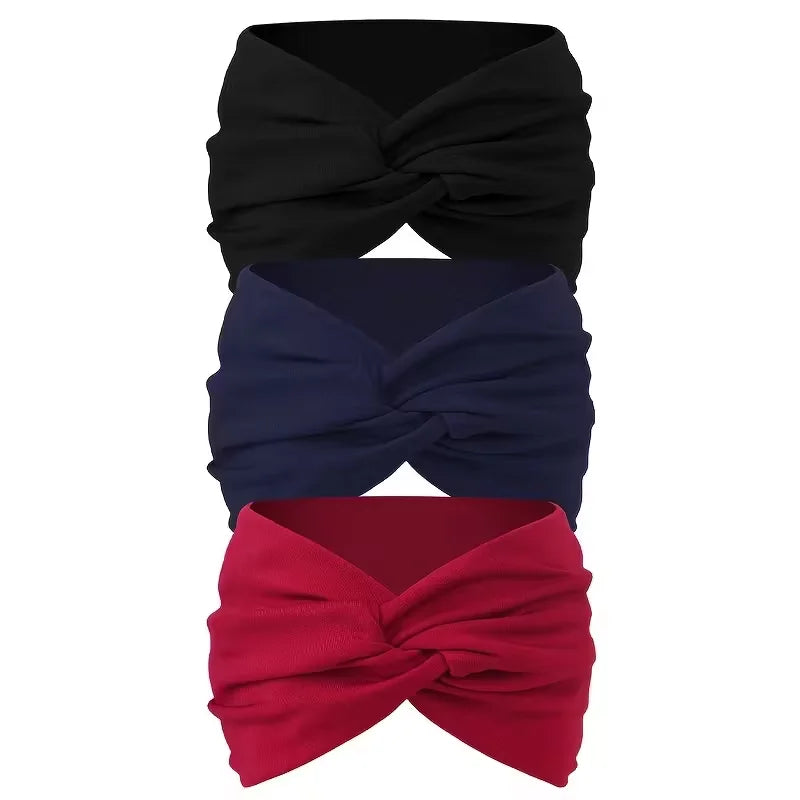 Ein Set aus drei rutschfesten, breiten Haarbändern in Schwarz, Marineblau und Rot, zu einer Schleife gebunden.