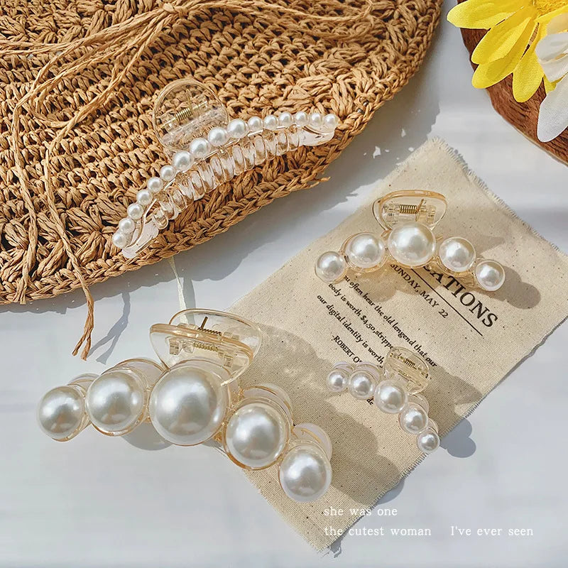 A set of simulated pearl hair claws displayed on a piece of parchment paper next to a woven basket.