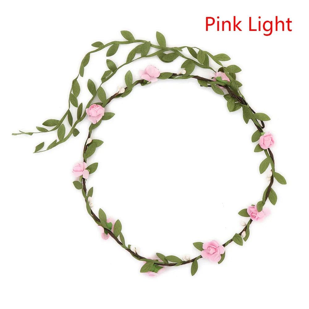 A green floral headband with pink roses used as a light source.