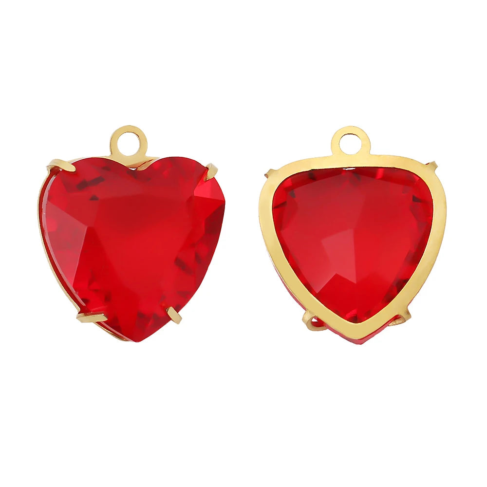A pair of red heart crystal pendants set with gold-toned findings.