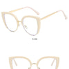 A pair of light beige vintage metal cat eye eyeglasses shown from the side and front views.