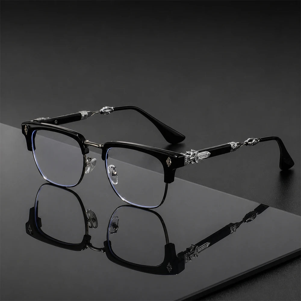 Paire de lunettes vintage noires à demi-monture avec des verres clairs et des accents de cristal décoratifs sur une surface s