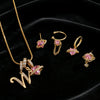 Gold alphabet letter pendant necklace featuring pink gemstone flowers and gold chain