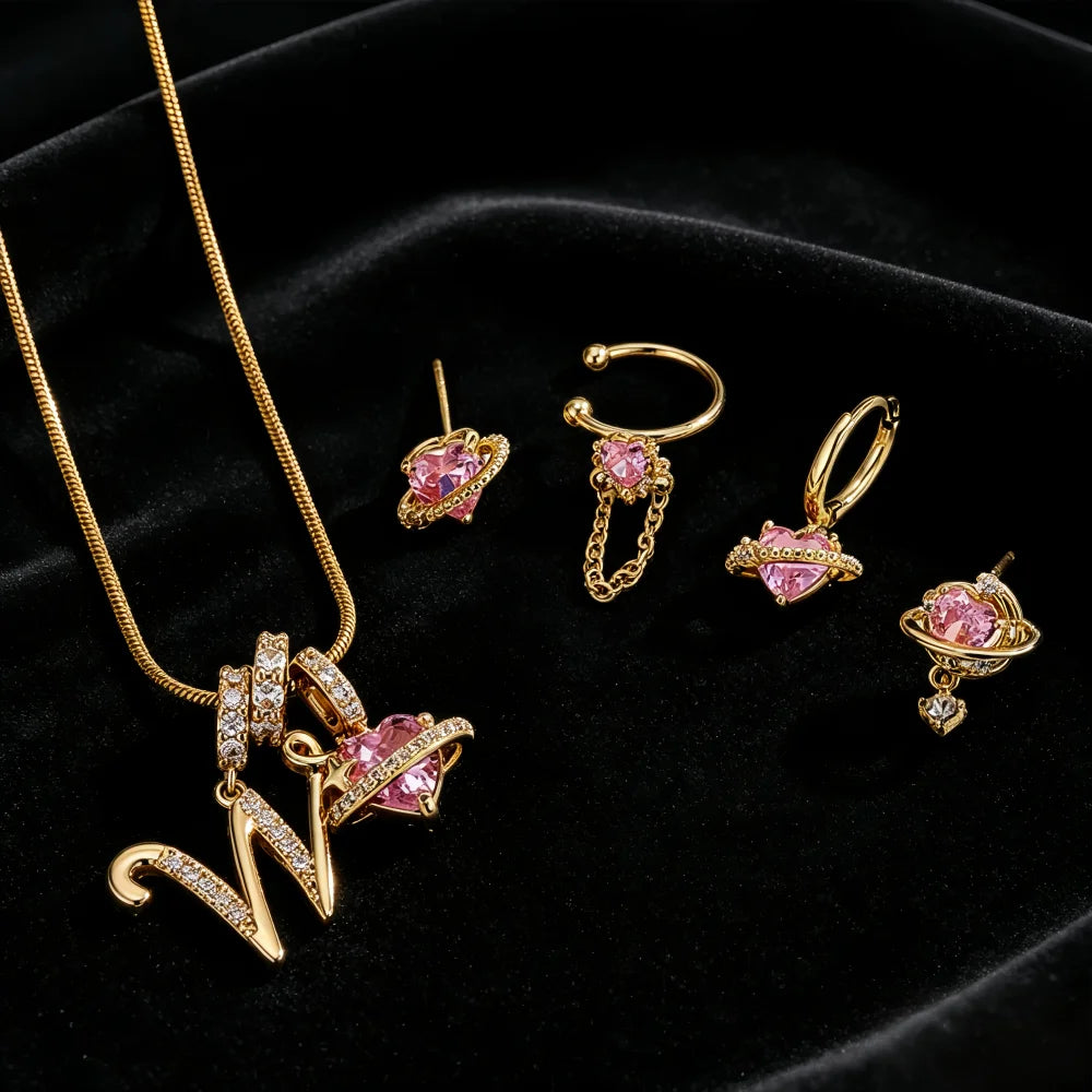 Gold alphabet letter pendant necklace featuring pink gemstone flowers and gold chain