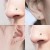 Close-up shots of magnetic nose stud earrings in gold tone with cubic zirconia stones.
