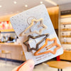 A set of vintage frosted geometry hair clips in beige and brown tones displayed on a white card.