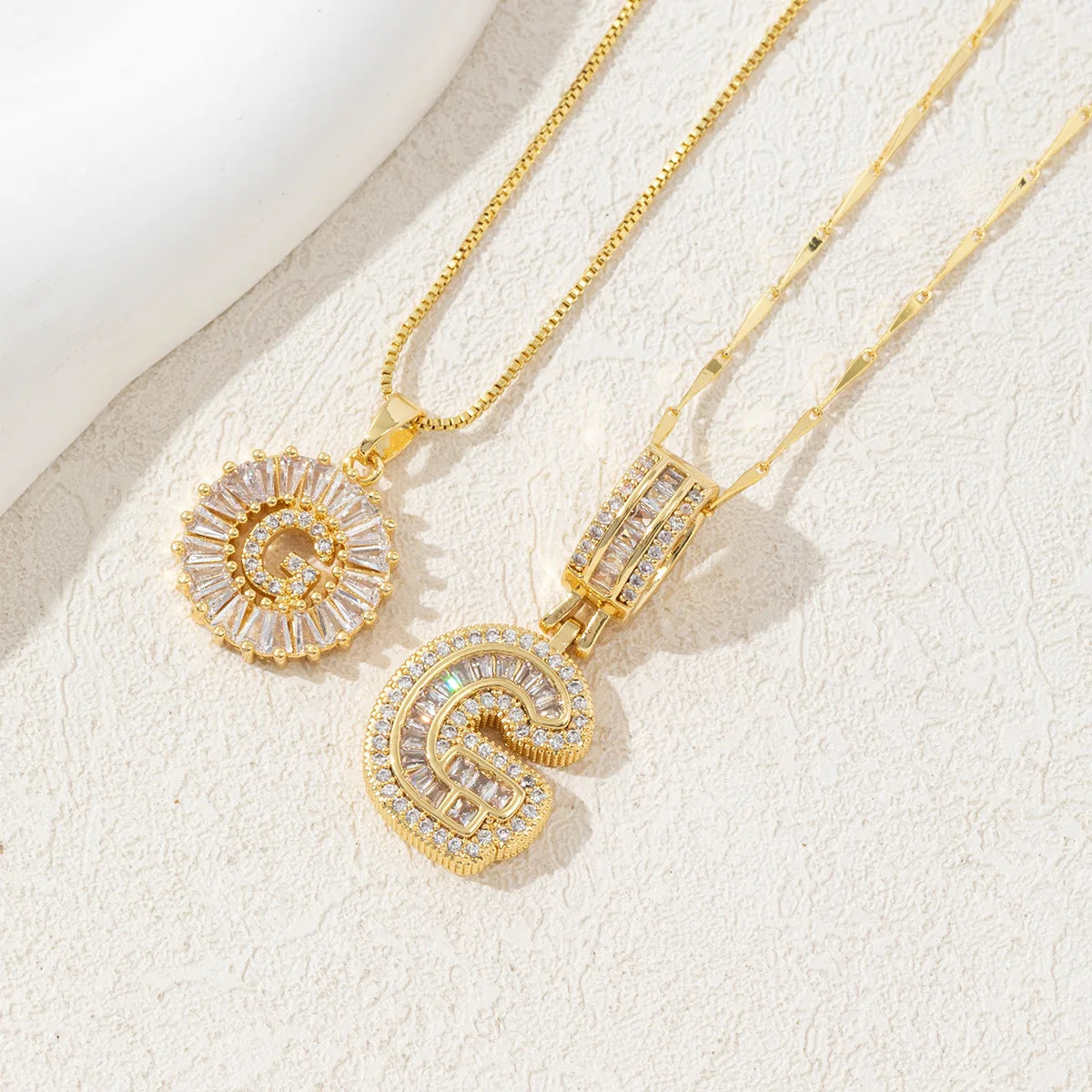 Gold-toned necklace set featuring CZ crystal pendants shaped like the letters A and Z.