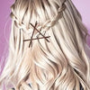 A close-up of blonde hair styled in a braid with brown bobby pins