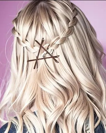 A close-up of blonde hair styled in a braid with brown bobby pins