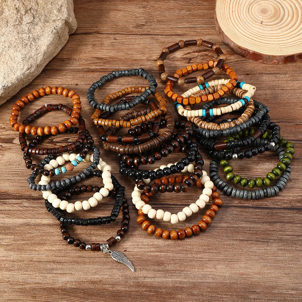 A collection of fashion elastic wood bead bracelets in various shades of brown, black, white, and blue laid on a wooden surfa