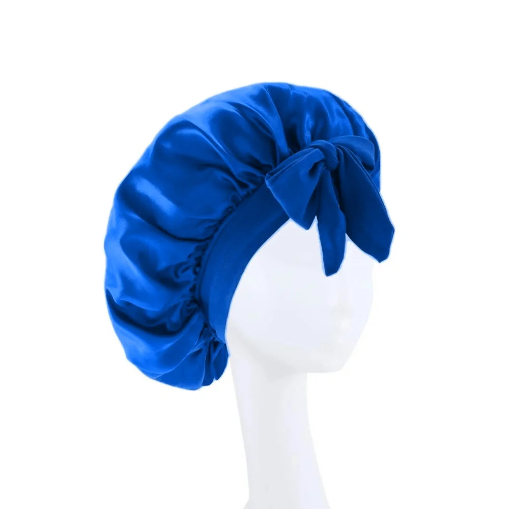 A royal blue satin wide-brimmed hair wrap headscarf tied in a bow displayed on a white mannequin.