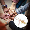 Hands joining together to display a gold and pink Virgin Mary Saint Jude Protection Catholic charm.
