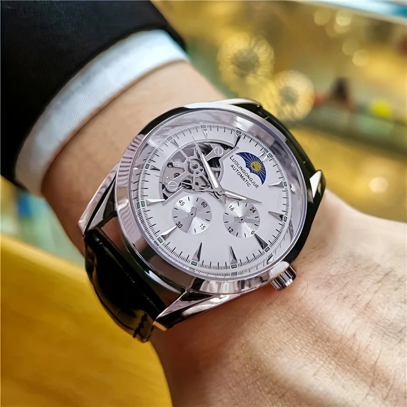 A close-up of a silver luxury automatic mechanical men's wristwatch worn on a person's wrist.