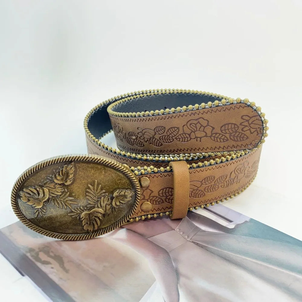 A vintage PU leather boho western belt in brown leather with embossed floral patterns.