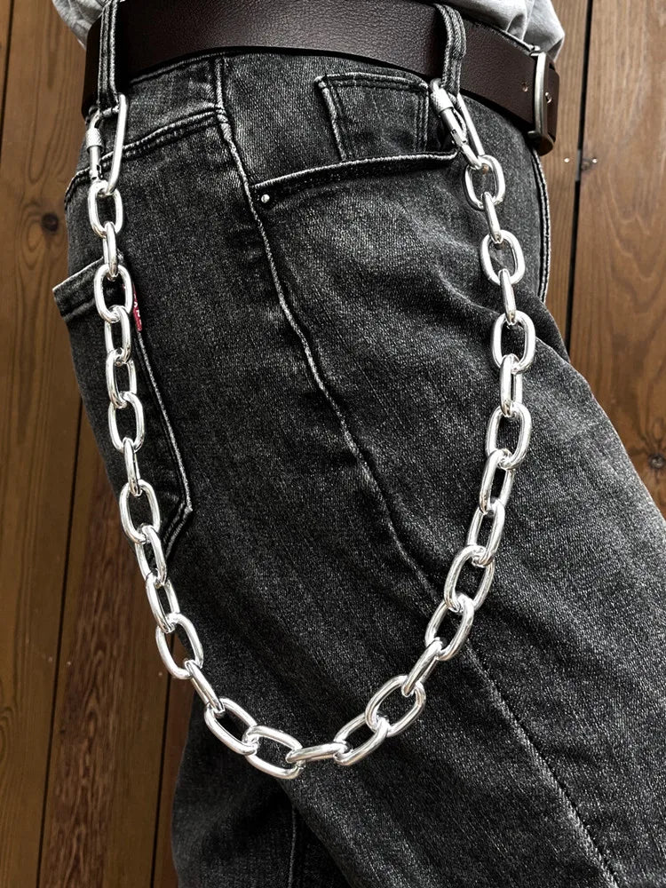 Nahaufnahme dunkle Jeans mit silberner Kettendetail am Hosentasche.