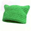 A bright green crocheted beanie hat with ear flaps.