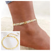 Gold stainless steel snake chain anklet worn on a foot.