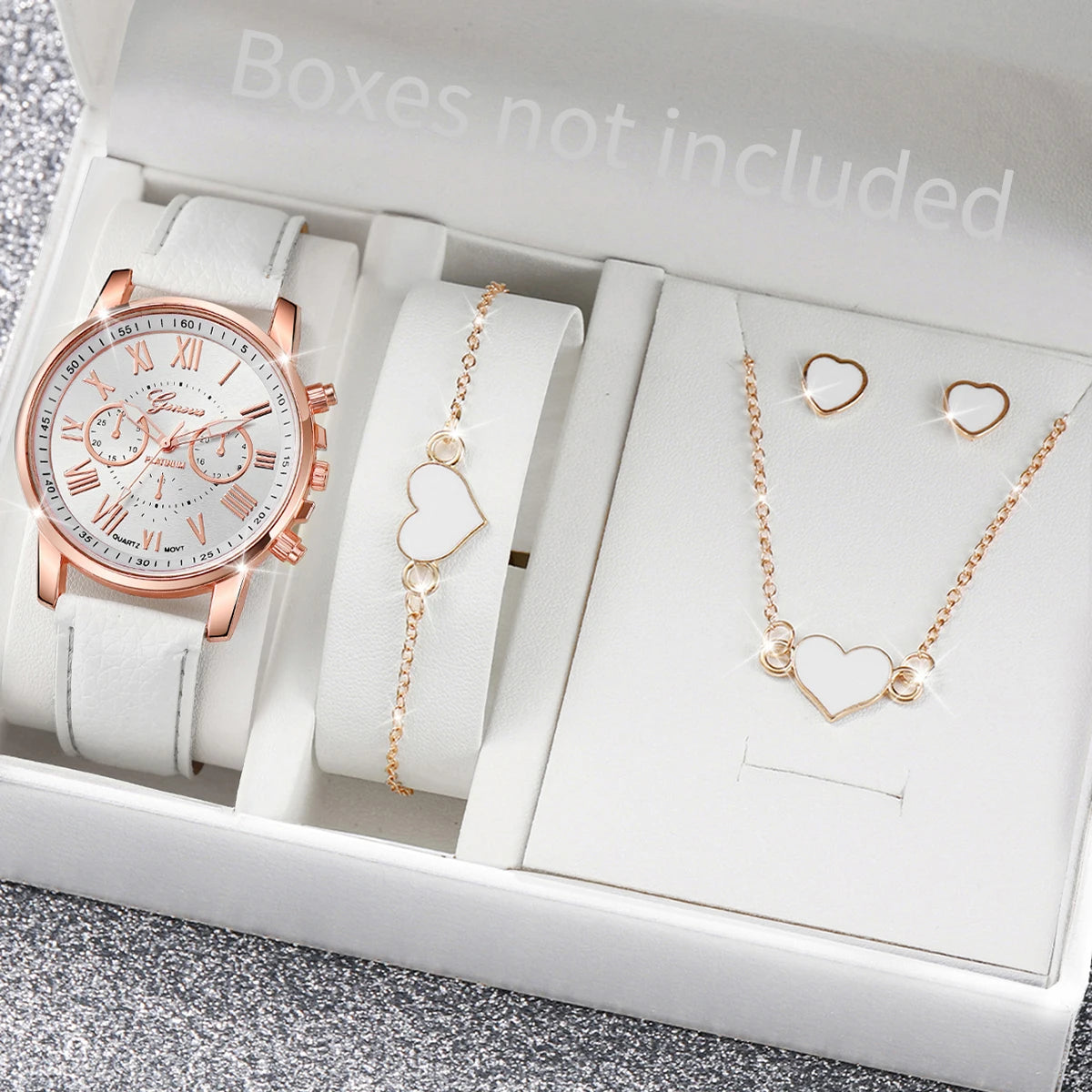 A box contains a rose gold fashion quartz wristwatch with a leather strap, a gold heart necklace, and matching earrings.