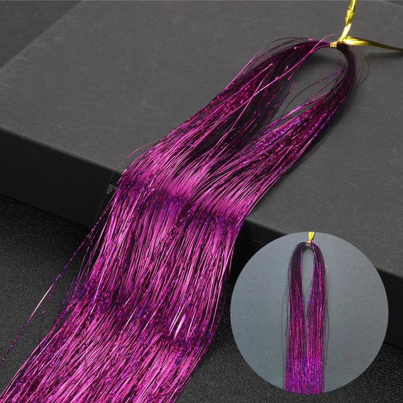 Long, vibrant magenta glitter hair extensions shown against a dark background.