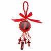 A red wooden cross pendant with a decorative ribbon and hanging charms.