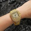 A gold-toned diamond crystal quartz wristwatch worn on a person's wrist.