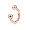 A close-up of a rose gold crystal horseshoe barbell ring set with spherical beads.