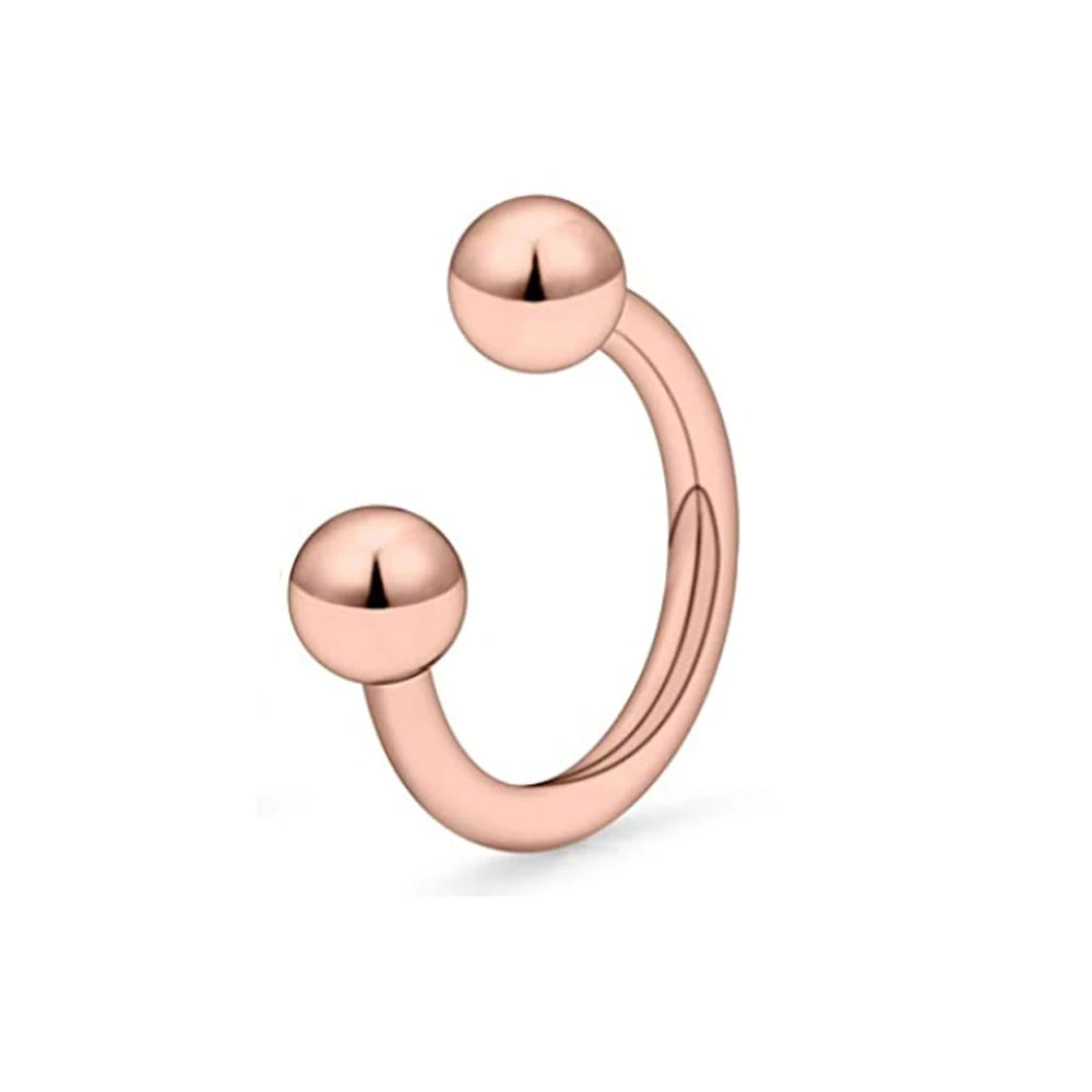 A close-up of a rose gold crystal horseshoe barbell ring set with spherical beads.