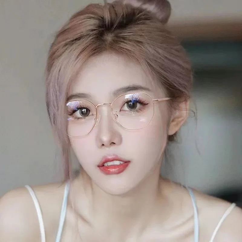 Gros plan d'une femme portant des lunettes vintage anti-lumière bleue à monture métallique fine.