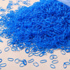 A pile of bright blue disposable rubber hair ties for kids scattered on a light surface.