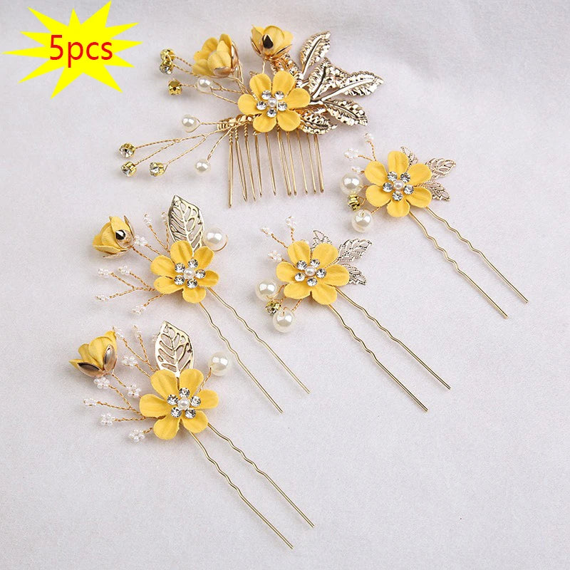 A set of five gold floral pearl bridal hair accessories featuring yellow flowers and leaves.