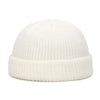 A white knitted beanie cap with a ribbed brim shown from the front.