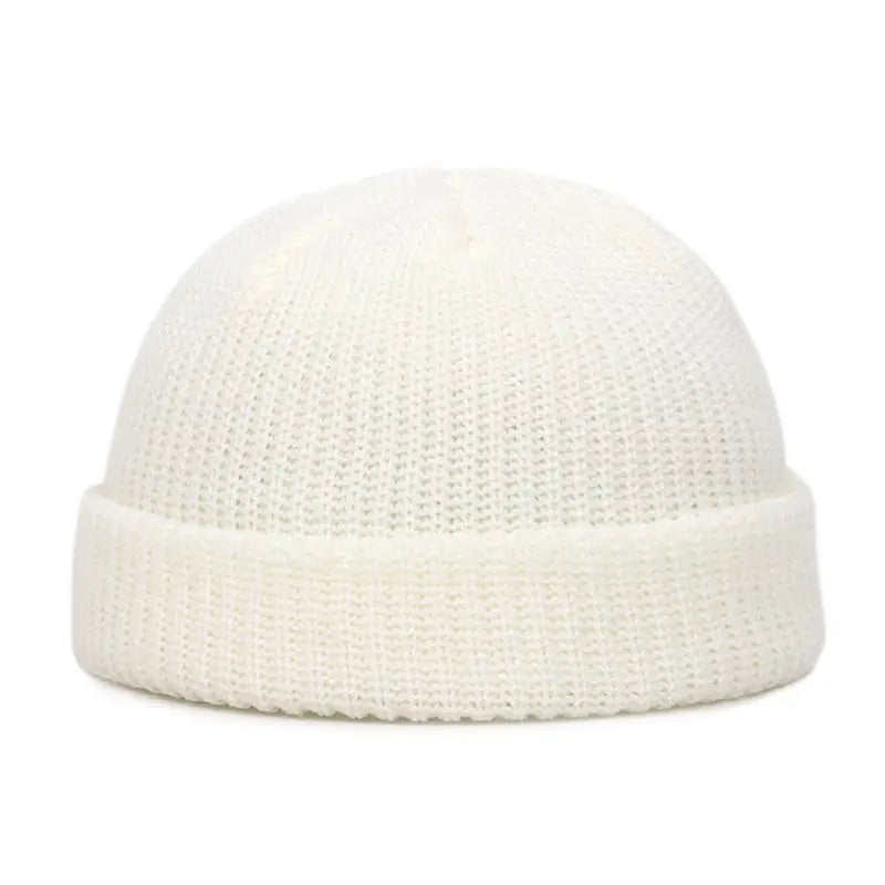 A white knitted beanie cap with a ribbed brim shown from the front.