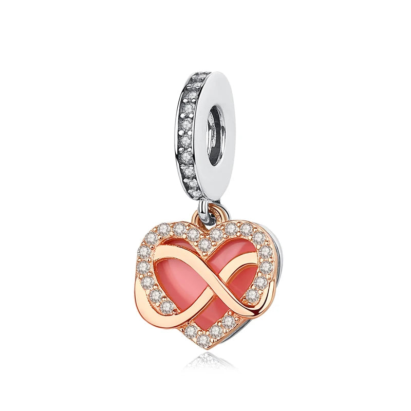 A silver family tree charm featuring an intertwined heart design with pink and clear stones.