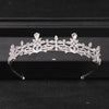 A sparkling crystal rhinestone bridal tiara headpiece displayed on a dark surface.