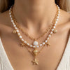 Gold layered necklace featuring white pearls and a starfish pendant