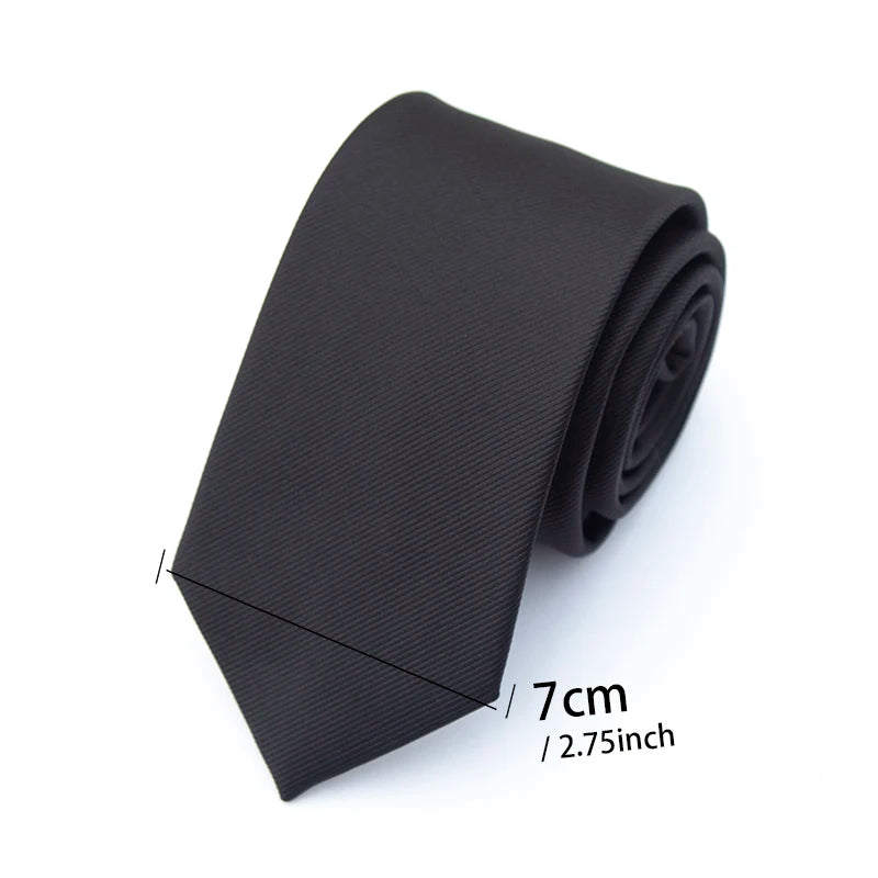 A solid black necktie folded neatly on a white background.
