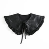 Black leather blouse with a ruffled false collar and tie detail.