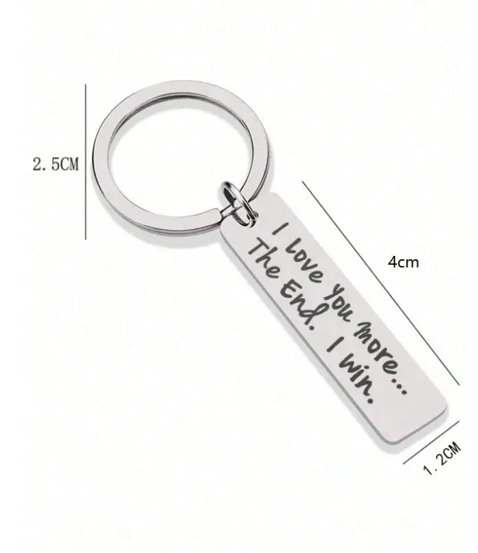Silver keychain with a circular ring and a rectangular tag engraved with the message I Love You The End I Win