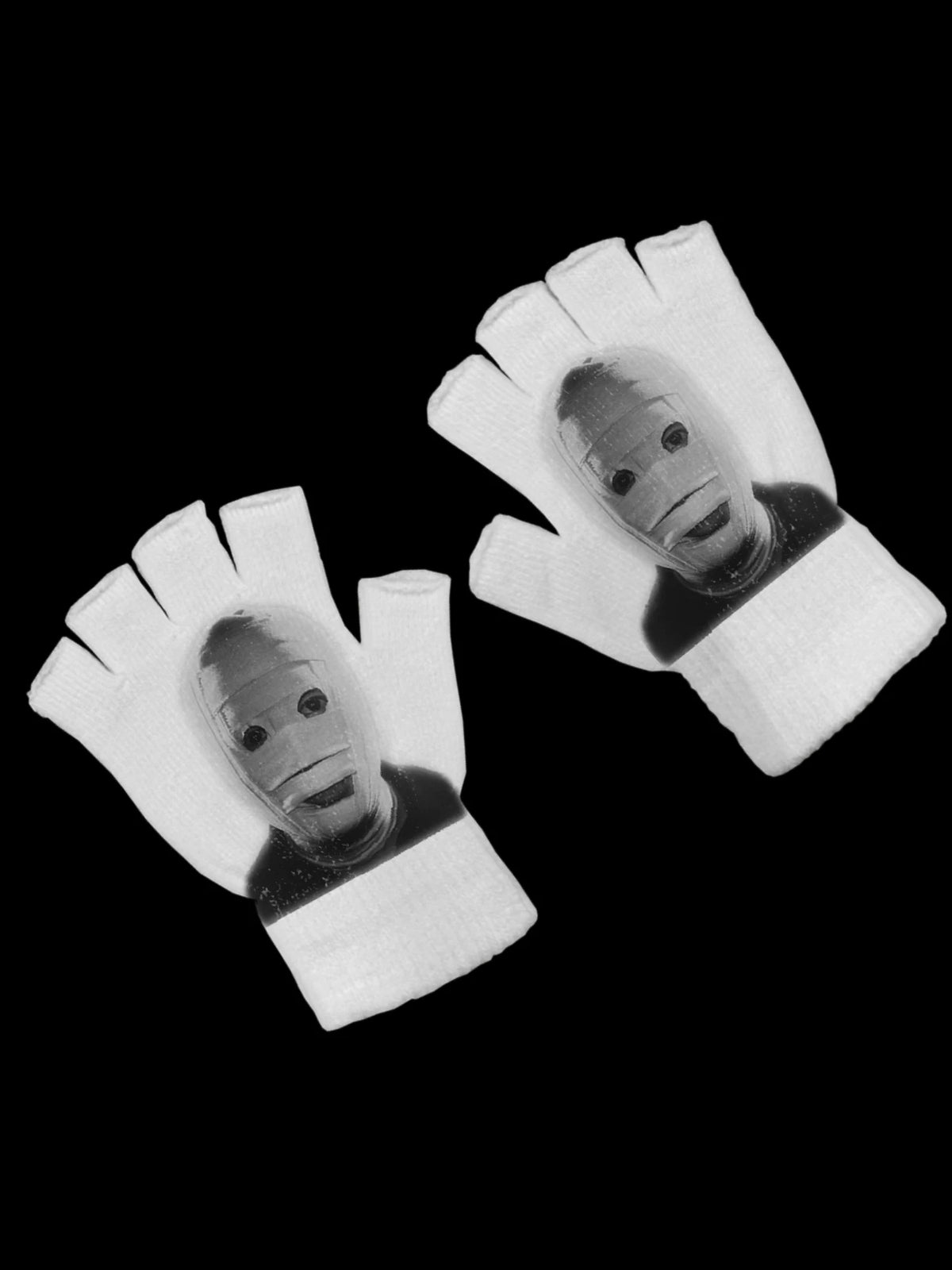 Pair of white fingerless knit gloves with a printed design on the palm and fingers.