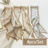 A set of four silk satin hair and bag accessories featuring various striped and patterned fabric designs.