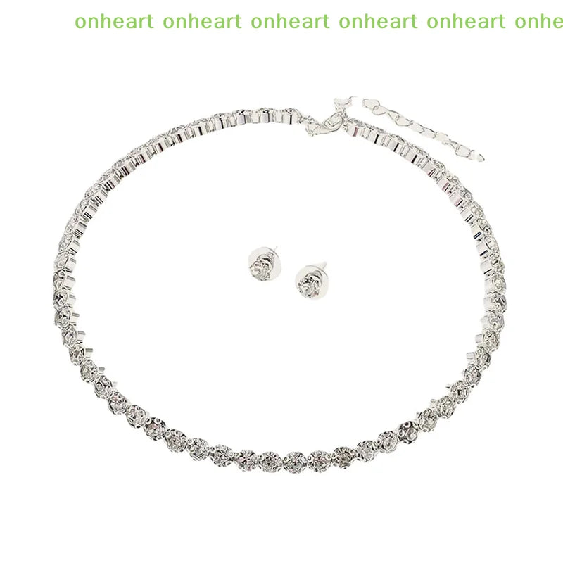 A delicate silver necklace and matching earrings set featuring clear crystals.
