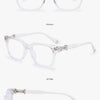 A set of clear, transparent square eyeglasses shown in various views and angles.