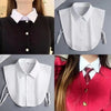A close-up of a detachable decorative collar for shirts and sweaters shown on a black and white garment.