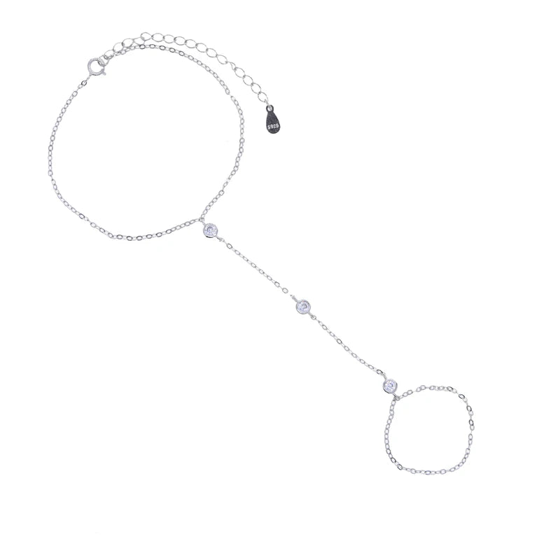 A delicate 925 sterling silver geometric bezel charm bracelet with a chain and a circular charm.