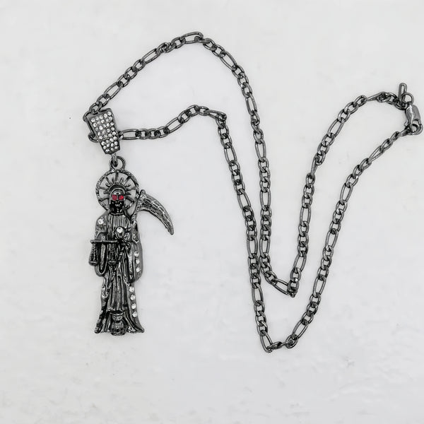 A silver pendant necklace featuring a figure of Santa Muerte with a crown and a skull.