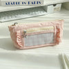 A pink lace pencil case with a clear window and a star charm resting on a white surface.