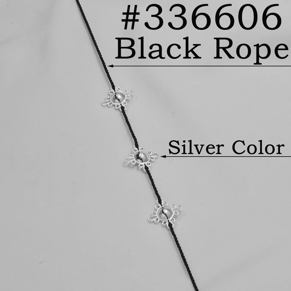 Black rope with silver colored beads shown against a white background